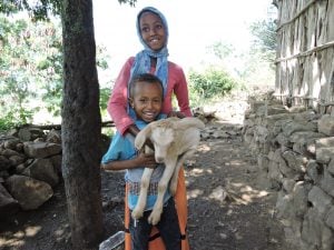 Truth About Goats: Two children proudly showcase their family goat.