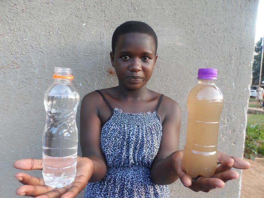 Ripple Effect: Joan holds bottles of dirty water and clean water. World Water Day 2018. Nature for Water #NatureForWater #WWD2018 #WorldWaterDay