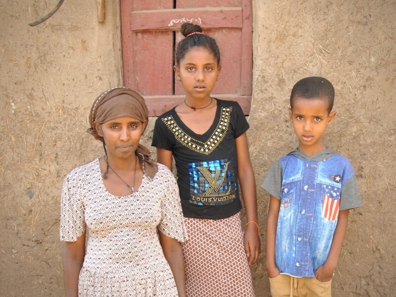 A mother's promise: Yeshi, a sheep farmer, with her two children in Ethiopia