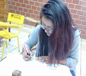 Fabiola writing her her notebook