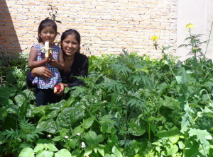 Urban gardens add fruits, veggies and income and mean less child hunger for Bolivia families like this one.