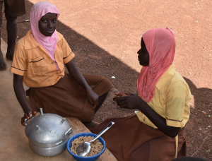 Serving lunch in Ghana. School food programs can keep girls in school. 