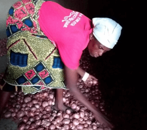 Esther standing among her harvested crops