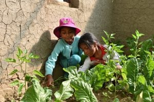 Two little girls gardening in their community garden