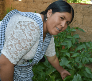 A woman shows off her garden crops