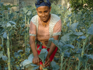 Kidist stands in her home vegetable garden in Ethiopia. 