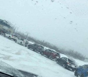 Long line up of cars to get into a parking lot