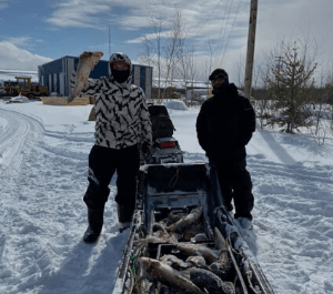 Two men holding fish they caught