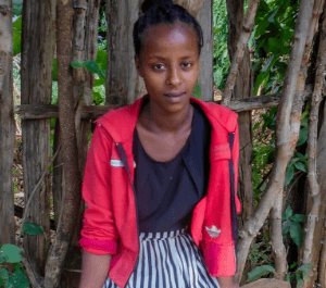 A teenager girl smiles for a portrait for the camera