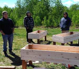 Community members building and constructing planter boxes