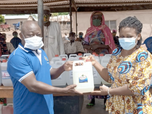 group of people in masks holding water stations