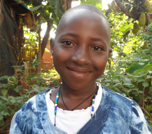 a young girl stares into the camera smiling