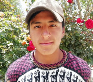 a young man in baseball cap smiles for the camera