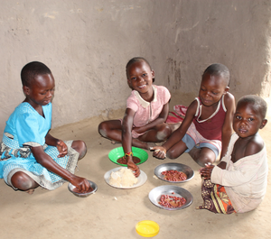 four young children eating lunch together
