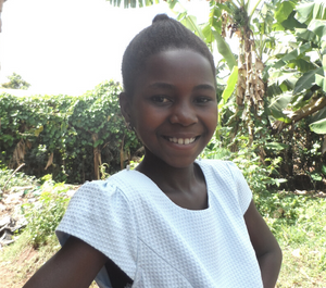 a smiling headshot of a young girl