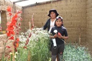 Gladis with her son in the flower garden