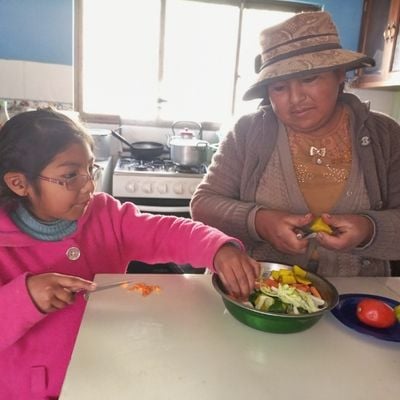 mother and daughter make a salad at home