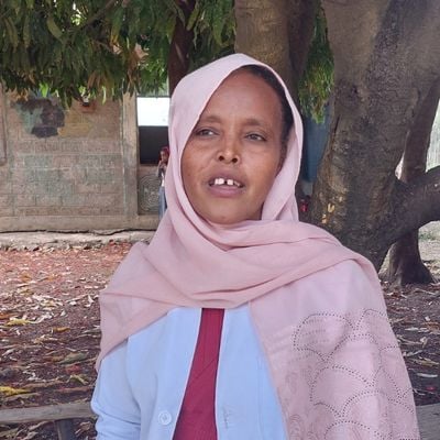 Sichale, a primary school teacher, looks off to her right while giving an interview in Ethiopia.