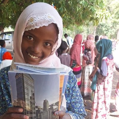 Hanan smiles with her new exercise books