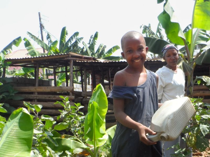 Anna Maria with her mother in their home garden