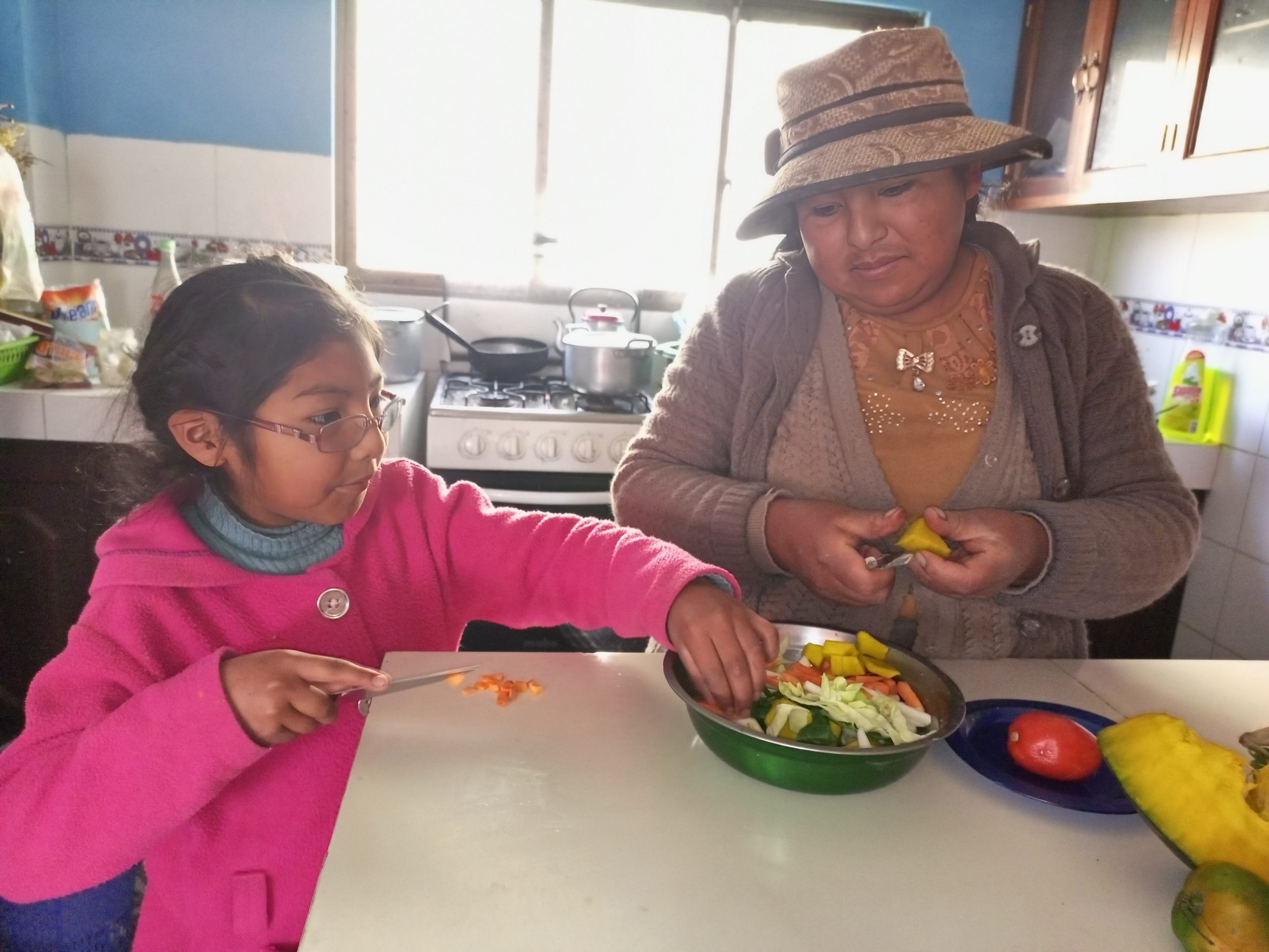 Viviana and Ana Lucia prepare food. 