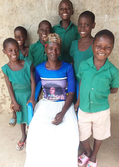 A Ghanaian family of a mother and six children all smile for the camera