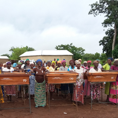 group of women in front of their beehives