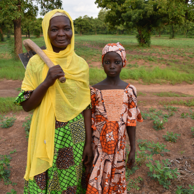 a woman and her daughter stand in their garden