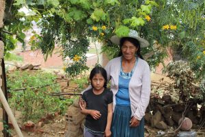 a woman andher child stand in front of the garden