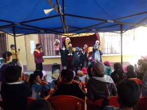 a group of students putting on a puppet show for the crowd