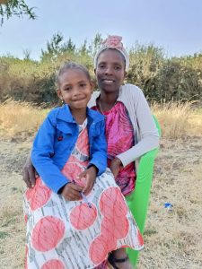 mother sits with her daughter on a chair