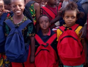 children holding backpacks