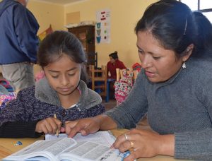 a mom and daughter reading a book together