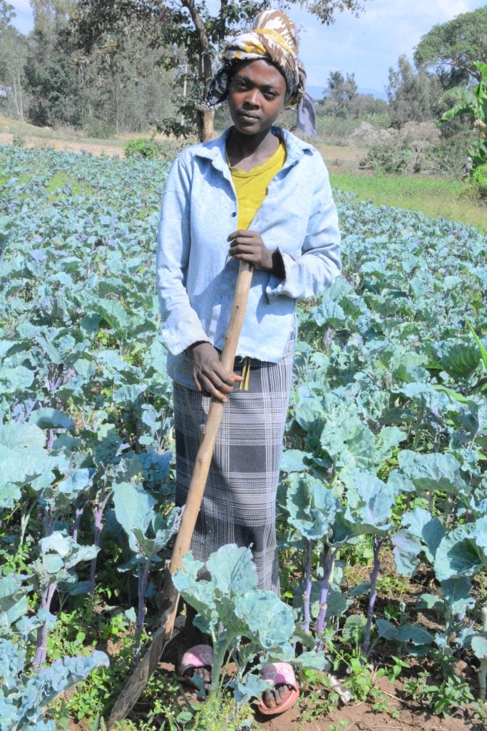 Tekelu, tending to her new vegetable farm