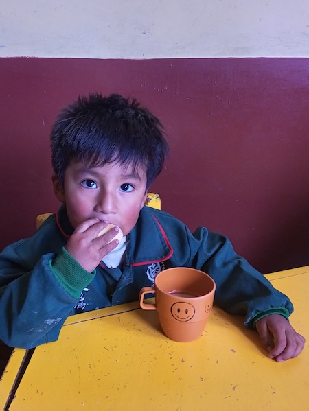Bolivian girl eating her lunch